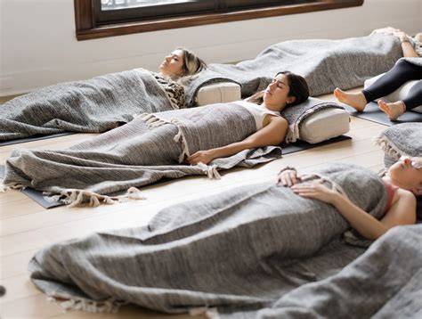 Persona in Savasana durante Yoga Nidra